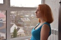 Pensive young woman with ginger hair