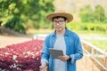 Portrait of young smart farmer using digital tablet computer for inspecting. using technology in agriculture field application in Royalty Free Stock Photo