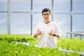 Portrait of young smart farmer using digital tablet computer for inspecting. using technology in agriculture field application in Royalty Free Stock Photo