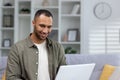 Portrait of young smiling African American male student studying remotely at home with laptop. Close-up photo Royalty Free Stock Photo