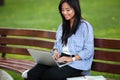 Portrait of a young smiling asian female student working Royalty Free Stock Photo