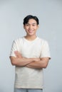 Portrait of young smiling asian man with crossed arms, isolated on white Royalty Free Stock Photo