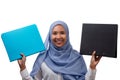 Portrait of young smiling asian muslim business woman in blue hijab holding two document folders isolated over white background Royalty Free Stock Photo