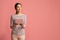 Portrait Of Young Smiling Asian Woman Holding Digital Tablet And Looking Away Royalty Free Stock Photo