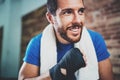 Portrait of Young smiling athlete tying black boxing bandages.Boxer man prepairing before kickboxing training. Blurred Royalty Free Stock Photo