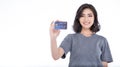 Portrait of young smiling beautiful Asian woman presenting credit card in hand showing trust and confidence making payment. Royalty Free Stock Photo