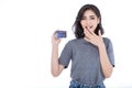 Portrait of young smiling beautiful Asian woman presenting credit card in hand showing trust and confidence making payment. Royalty Free Stock Photo