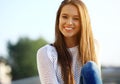 Portrait Of Young Smiling Beautiful Woman. Close-up portrait of a fresh and beautiful young fashion model posing outdoor Royalty Free Stock Photo