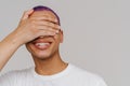 Portrait of young smiling boy covering his eyes with hand Royalty Free Stock Photo