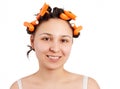 Portrait of a young smiling brunette woman with curlers in her hair Royalty Free Stock Photo