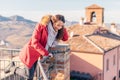 Portrait of young smiling brunette woman looking down from terrace Royalty Free Stock Photo