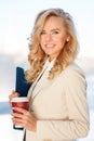 Portrait of young smiling businesswoman with folder and coffee Royalty Free Stock Photo