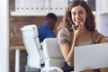 Portrait Of Young Smiling Businesswoman Working At Desk In Office Talking Into Mic Of Mobile Phone Royalty Free Stock Photo