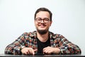 Portrait of young smiling caucasian man on white background. Man wearing eyeglasses, watch and casual denim shirt Royalty Free Stock Photo