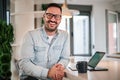 Portrait of young smiling cheerful businessman entrepreneur in office looking at camera Royalty Free Stock Photo