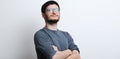 Portrait of young smiling confident man over white background. Wearing glasses and grey sweater Royalty Free Stock Photo