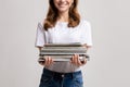 Portrait Of Young Smiling Female Holding Stack Of Old Magazines In Hands Royalty Free Stock Photo