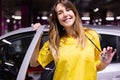 Portrait of young smiling female nurse getting out of her vehicle ready to start work Royalty Free Stock Photo