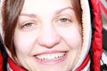 Portrait of a young smiling girl in red, close-up face, in a winter headdress Royalty Free Stock Photo