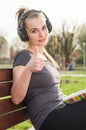 Portrait of young smiling girl showing like gesture outside Royalty Free Stock Photo