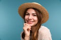 Portrait of a young smiling girl in summer hat isolated over blue background Royalty Free Stock Photo