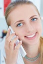 Portrait of a young smiling girl talking on the mobile phone . Royalty Free Stock Photo