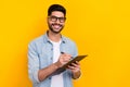 Portrait of young smiling happy man writing paper pad work document isolated on yellow color background Royalty Free Stock Photo