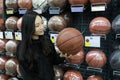 Asian chinese choosing balls, Soccer ballsarea in Decathlon store