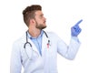 Portrait of a Young smiling male doctor pointing finger away isolated on a white background Royalty Free Stock Photo