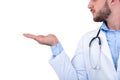 Portrait of a Young smiling male doctor pointing finger away isolated on a white background Royalty Free Stock Photo