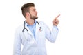 Portrait of a Young smiling male doctor pointing finger away isolated on a white background Royalty Free Stock Photo