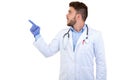 Portrait of a Young smiling male doctor pointing finger away isolated on a white background Royalty Free Stock Photo