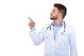 Portrait of a Young smiling male doctor pointing finger away isolated on a white background Royalty Free Stock Photo