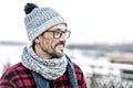 Portrait of young smiling man profile in glasses and warm knitted clothes for city man. Royalty Free Stock Photo