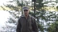 Portrait of Young Smiling Man Standing in Forest. Traveling Concept People in Nature. One Person Tourist Looking at Royalty Free Stock Photo