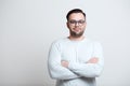 Portrait of young smiling man wearing blue glasses over white background Royalty Free Stock Photo