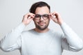 Portrait of young smiling man wearing blue glasses over white background Royalty Free Stock Photo