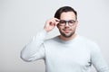 Portrait of young smiling man wearing blue glasses over white background Royalty Free Stock Photo