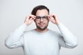 Portrait of young smiling man wearing blue glasses over white background Royalty Free Stock Photo