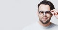 Studio portrait of young man wearing eyeglasses on white background with copy space. Royalty Free Stock Photo