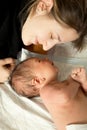 Portrait of young smiling mother lying with her 1 month old baby Royalty Free Stock Photo