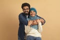 Portrait Of Young Smiling Muslim Couple Embracing Over Beige Background Royalty Free Stock Photo