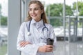 Portrait of young smiling nurse or doctor having a coffee break in hospital. COVID-19, Coronavirus pandemic. Royalty Free Stock Photo