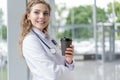 Portrait of young smiling nurse or doctor having a coffee break in hospital. COVID-19, Coronavirus pandemic. Royalty Free Stock Photo