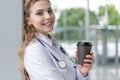 Portrait of young smiling nurse or doctor having a coffee break in hospital. COVID-19, Coronavirus pandemic. Royalty Free Stock Photo