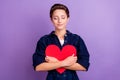 Portrait of young smiling peaceful dreamy woman hug embrace paper heart valentine day present isolated on purple color