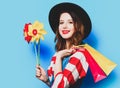 Woman with pinwheel and shopping bags Royalty Free Stock Photo