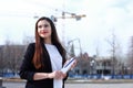 Portrait of young smiling successful business woman. People, cute, outdoor.