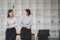 Portrait of young smiling two woman look at each othe with crossed arms. Royalty Free Stock Photo