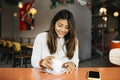 Young woman drinking coffee in a coffee shop Royalty Free Stock Photo